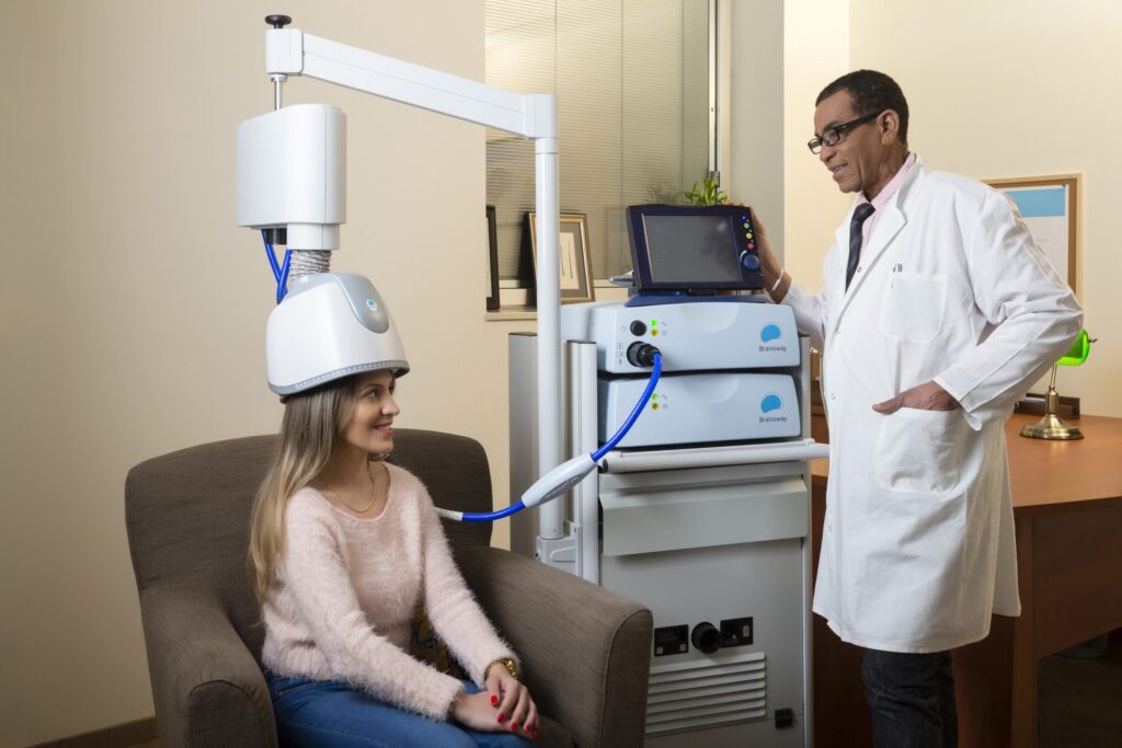 Woman receiving TMS treatment.