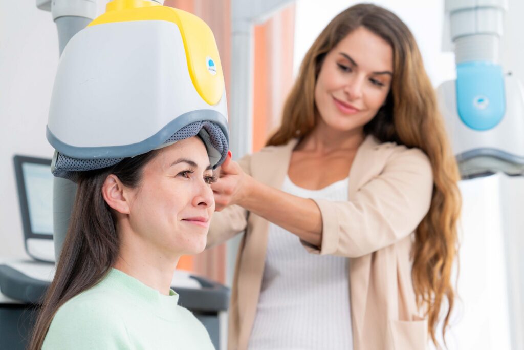 Female receiving TMS treatment